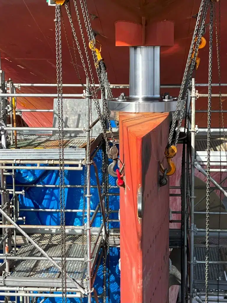 Rudder being installed after repair completed